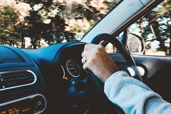 hand on the wheel of a car