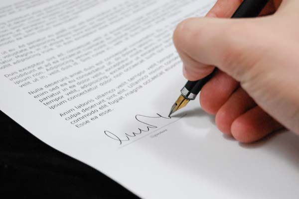 person signing a document